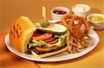 Cheeseburger with Onion Rings and French Fries