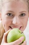 Woman holding green apple