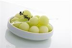 Honeydew Melon Balls in Dish with Thyme Sprig