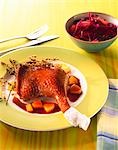 Goose leg with pieces of pear and red cabbage