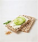 Sesame crispbread with soft cheese, cucumber and chives