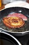 Frying duck breast in a frying pan