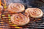 Coiled sausages on barbecue rack