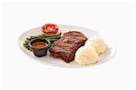 Beefsteak with mashed potato, beans, grilled tomato & sauce