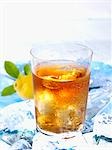 A glass of iced tea on ice with lemon