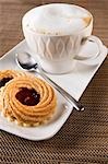 Cappuccino and hazelnut & redcurrant jam tarts