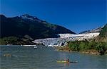 Person kayaking on Mendenhall Lake w/glacier Coast Mtns Tongass Nat Forest Southeast AK Summer