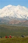 Two hikers view McKinley from tundra at Eielson visitor center summer Denali National Park Alaska