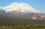 Two hikers view McKinley from tundra at Eielson visitor center summer Denali National Park Alaska