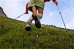 Hiker runs uphill in the Chugach Mountains during a rugged 32-mile link-up trail of Chugach front range peaks Southcentral Alaska summer