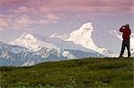 Male tourist views Mt.Mckinley & Alaska Range near Wonder Lake Denali National Park Alaska Summer