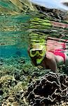 Snorkeler on coral reef.