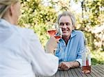 Couple toasting with wine outdoors