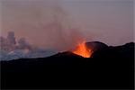 Fountaining lava from Eyjafjallajokull volcano, silhouetted against sunset, Southern Iceland