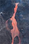 Lava from Eyjafjallajokull volcano flowing down mountain, silhouetted against sunset, Southern Iceland