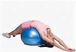 Young woman exercising on a fitness ball