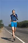 Woman jogging at the roadside