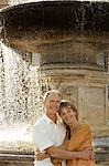 Middle-aged couple hugging by fountain, Rome, Italy, portrait