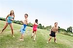 Boys and Girls in Swimsuits playing in field