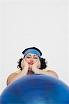 Uninspired overweight Woman Resting on Exercise Ball, portrait