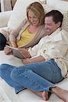 Couple sit reading a digital book