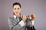 Businesswoman holding trophy, portrait