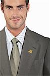 Businessman with gold star on suit, portrait