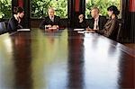 Businesspeople meeting around boardroom table