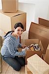 Young Woman Unpacking Boxes