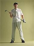 Golfer standing holding club