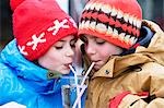 Two children drinking glass of water