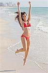 Happy Woman Jumping on the Beach