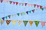 Multi coloured bunting against blue background