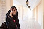 Middle Eastern woman using mobile phone