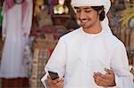 Middle Eastern man looking at mobile phone