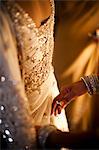 Hands Pinning Bride's Dress