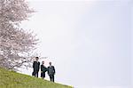 Businessmen and Businesswoman Standing in park