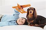 Miniature Dachshund And A Boy Relaxing