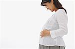 Pregnant Woman Smiling and  Touching her Stomach