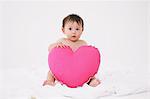 Baby Holding Cushion Of Heart