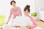 Grandmother And Granddaughter With Laundry