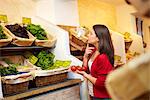 Adolescent dans un étal de fruits