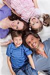 Happy family lying on rug