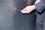 Man opening safe deposit box, close-up