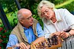 Senior couple on terrace playing chess