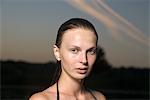 Portrait of young woman in swimming costume at dusk