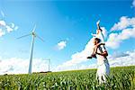 Farther and son looking at wind turbine