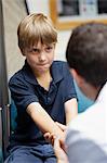 Doctor examining young boy