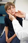 Doctor examining young boy