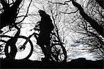 Silhouette man mountain biking